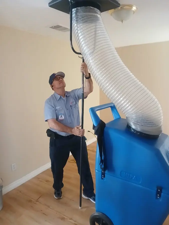 Furnace Tune-Up technician using HEPA equipment in San Leandro