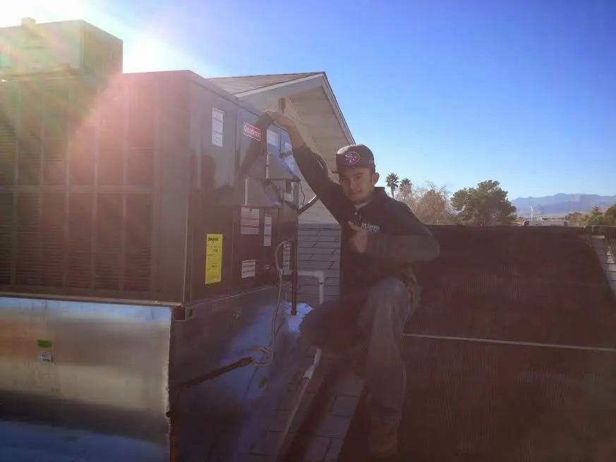 HVAC technician performing HVAC Inspection on a rooftop unit in San Leandro